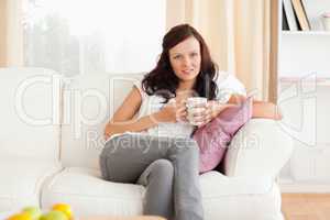 Smiling woman holding a cup