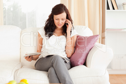 Woman with a magazine and a mobile phone