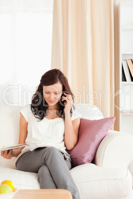 Woman on the phone reading a magazine