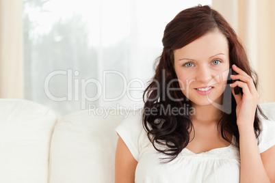 Young woman on the phone looking into the camera