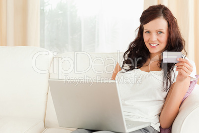 Gorgeous red-haired doing online shopping