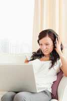 Young woman with headphones and a laptop