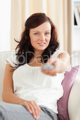 Cute Woman watching TV looking into the camera