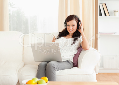 Happy woman with a notebook and headphones