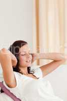 Relaxed red-haired woman listening to music