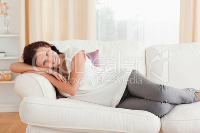 Woman relaxing on the sofa looking into the camera