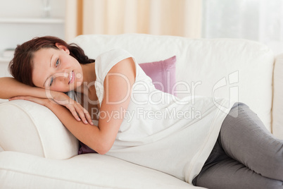 Relaxing cute woman lying on the sofa