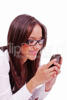 Beutiful happy woman sending text at mobile phone