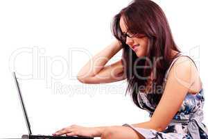 Pretty woman with confused expression working on laptop