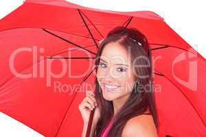 Beautiful young lady under a red umbrella isolated on white