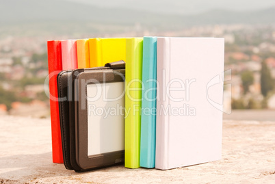 Row of colorful books with electronic book reader