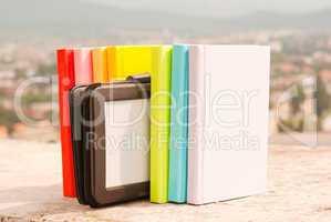 Row of colorful books with electronic book reader