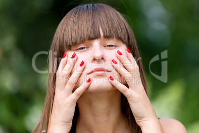 Young girl with red manicure