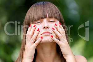 Young girl with red manicure