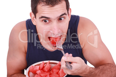 Young man eating a fresh water melon.