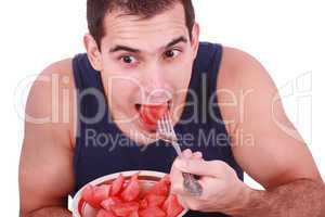 Young man eating a fresh water melon.