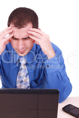 male frustrated with work sitting in front of a laptop.