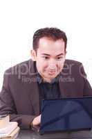 Businessman with amazed expression using a laptop .