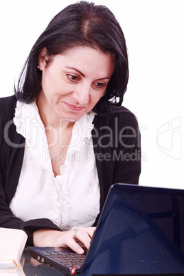 Beautiful businesswoman working on laptop in the office .