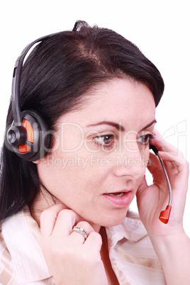 A beautiful young telephonist speaking on a headset .