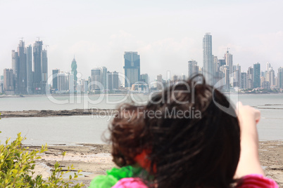 Mother shows her daughter a beautiful view over the city