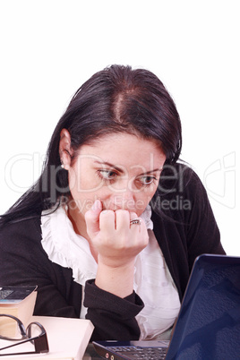 Office worker with thoughtful look in front of laptop computer