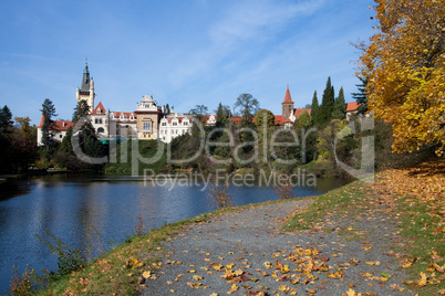 beautiful autumn landscape with colorful trees, a pond and a med