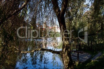 beautiful autumn landscape with colorful trees, a pond and a med