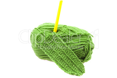 Skein of wool, crochet hook  and knitted piece isolated on white