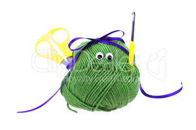 skein of wool with eyes, ribbon, scissors and crochet hooks isol