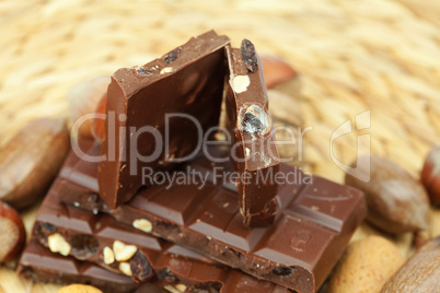 bar of chocolate and nuts on a wicker mat