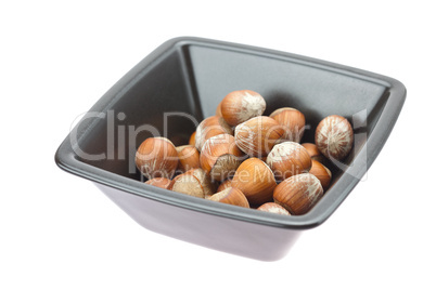 hazelnuts in a bowl isolated on white