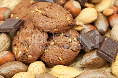 oatmeal cookies, chocolate and nuts on a wicker mat