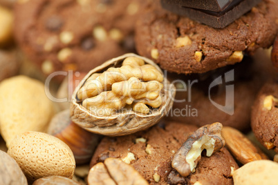 oatmeal cookies, chocolate and nuts on a wicker mat