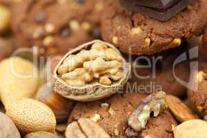 oatmeal cookies, chocolate and nuts on a wicker mat