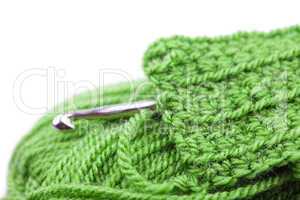 Skein of wool, crochet hook  and knitted piece isolated on white