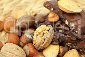 bar of chocolate and nuts on a wicker mat