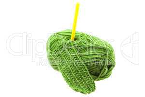 Skein of wool, crochet hook  and knitted piece isolated on white