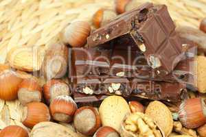 bar of chocolate and nuts on a wicker mat