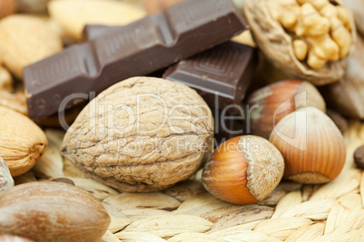 bar of chocolate and nuts on a wicker mat