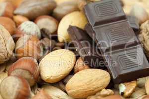 bar of chocolate and nuts on a wicker mat