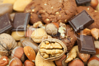 oatmeal cookies, chocolate and nuts on a wicker mat