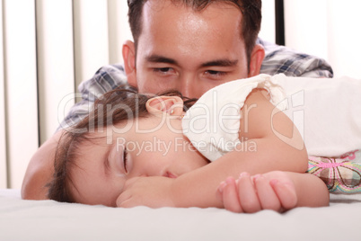 Father watch his beautiful baby while she sleeps