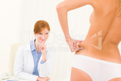 Plastic surgery consultation patient pinch hips