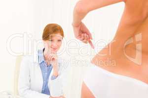 Plastic surgery consultation patient point hips