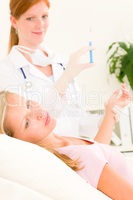 Medical doctor apply injection to woman patient Medical doctor apply injection to woman patient