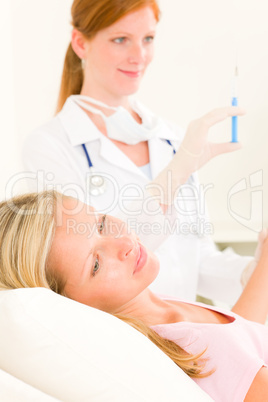 Medical doctor apply injection to woman patient