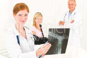 Medical doctors show x-ray patient broken arm