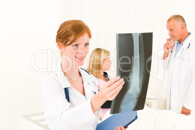 Medical doctors look x-ray patient broken arm