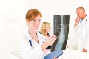 Medical doctors look x-ray patient broken arm